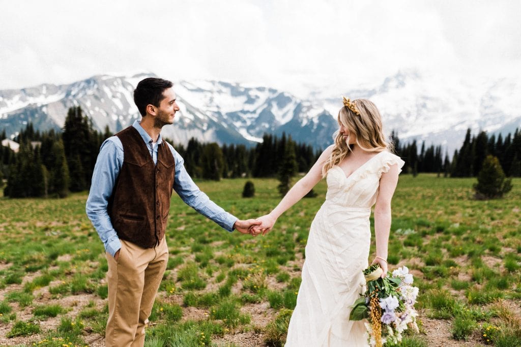 When deciding where to elope, consider a mountain elopement like this couple did at Mount Rainier National Park.