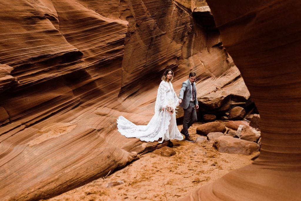 A couple exploring a slot canyon during their elopement day.