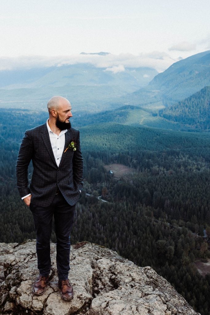 Groom at the top of Rattlesnake Ledge in North Bend, Washington during his adventure wedding