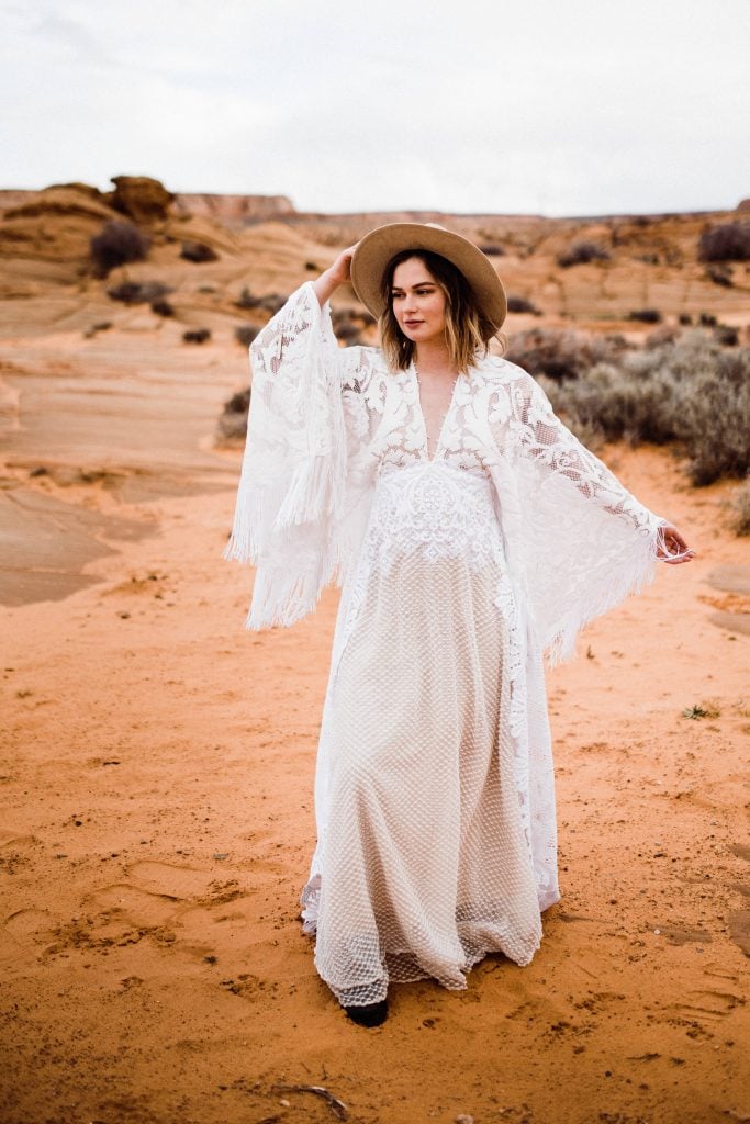 A bride wearing a dress from We Are Reclamation during her desert adventure elopement.