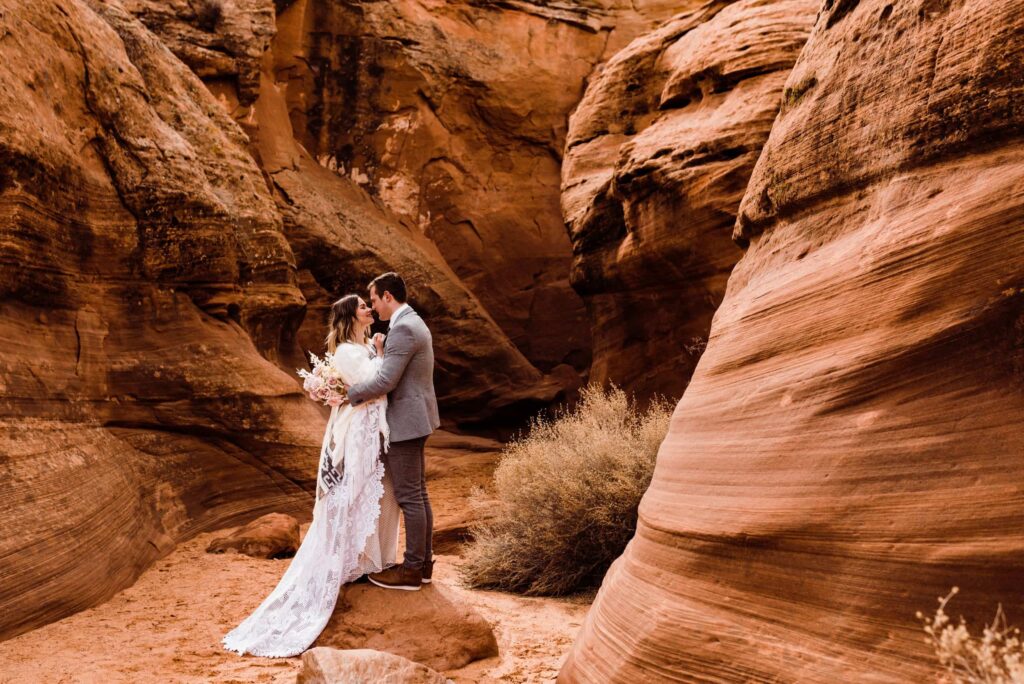 Bride and groom embracing during their elopement in a slot canyon near Page, Arizona.