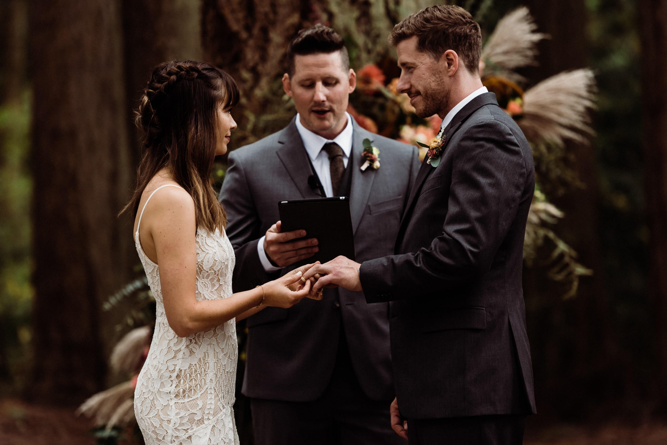 There are so many reasons to get married outdoor in the thick of nature like this couple exchanging rings during their forest wedding.